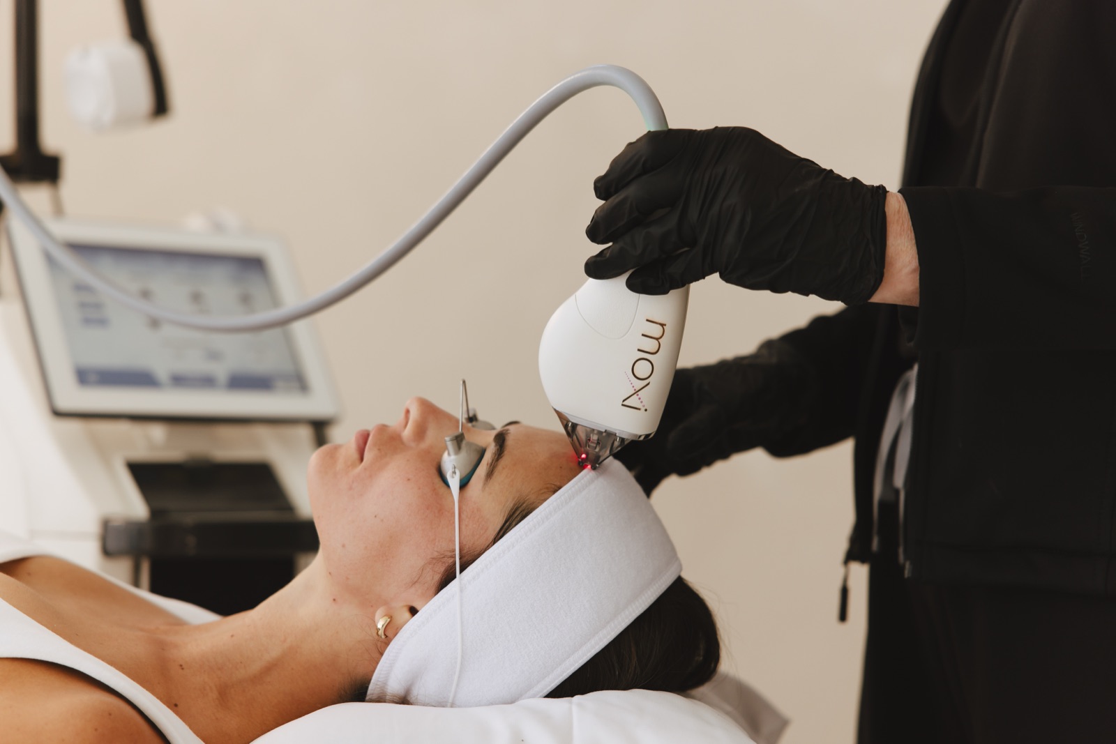 Natalia performs a MOXI laser facial treatment; the patient wears protective eye shields