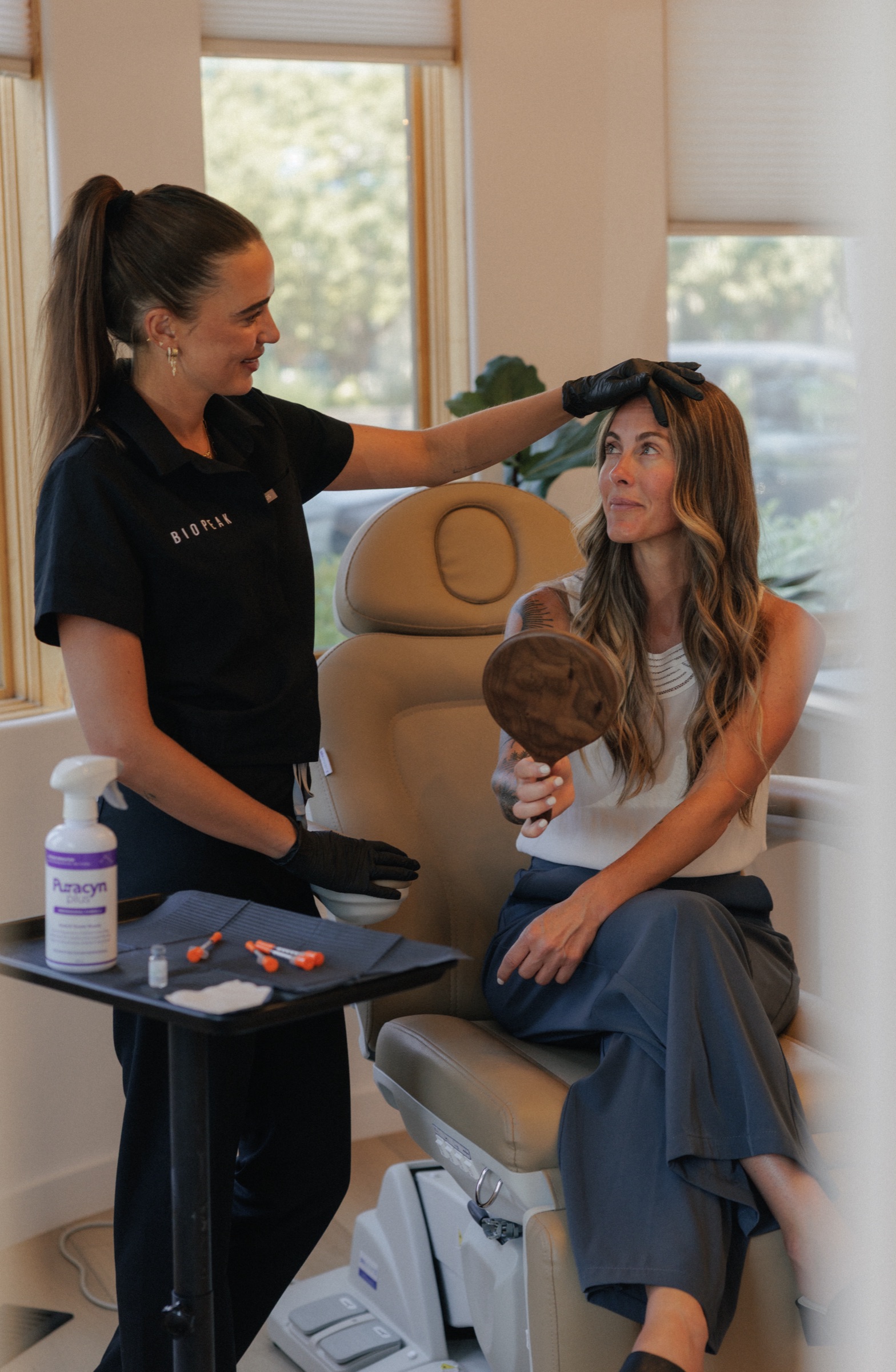 Natalia examines a patient's skin during a skin assessment