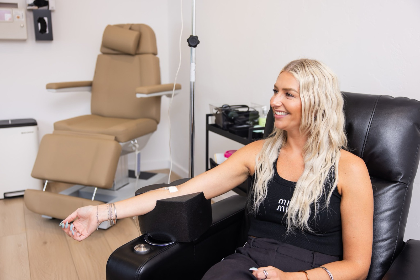 A patient smiles from a recliner during an IV infusion at BioPeak